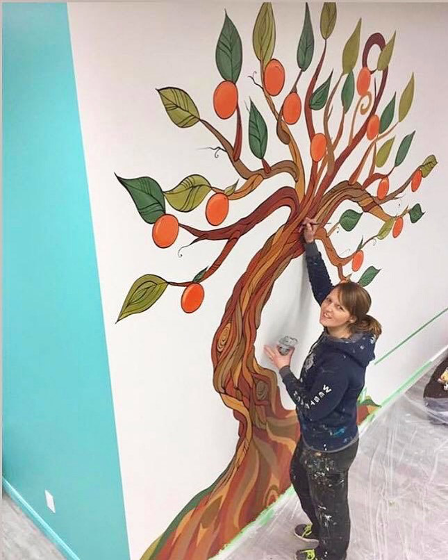 Action shot! April Lacheur's Mural at the Live Well Exercise Clinic in Langley 2017. (5 of this style of murals were created for this company for their various clinics)